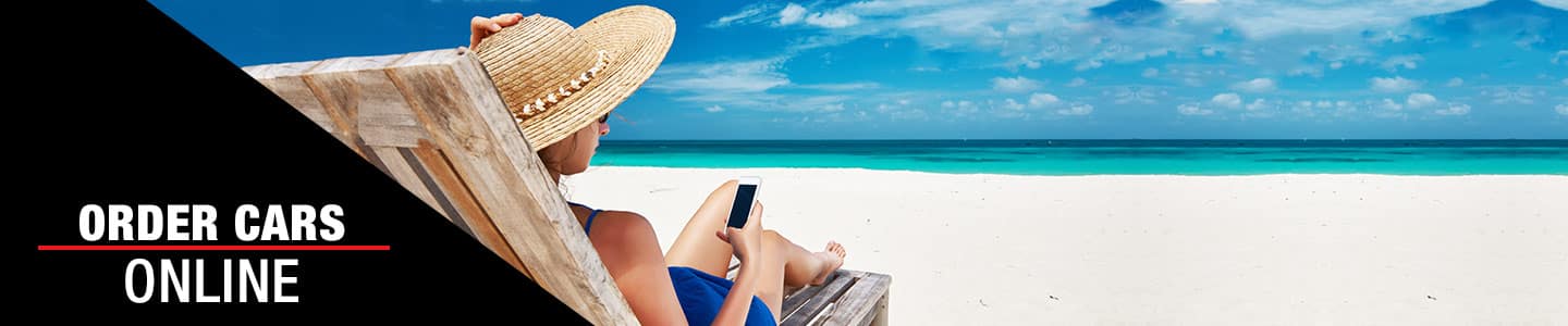 image of a woman on a beach looking at a phone